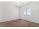 Bright bedroom with neutral carpet, base trim and a window providing lots of natural light at 6320 S 26Th Dr, Phoenix, AZ 85041