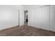 Bedroom with neutral carpet, base trim, an ensuite bathroom and a large closet at 6320 S 26Th Dr, Phoenix, AZ 85041