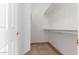 Walk-in closet featuring built-in shelving and tiled flooring at 6320 S 26Th Dr, Phoenix, AZ 85041