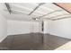 Spacious garage with epoxy flooring and ample room for vehicles and storage at 6320 S 26Th Dr, Phoenix, AZ 85041