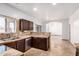 Kitchen with dark cabinetry, stainless steel appliances, and travertine flooring at 6320 S 26Th Dr, Phoenix, AZ 85041