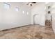 Open living space with travertine flooring, arched entryway, and lots of light at 6320 S 26Th Dr, Phoenix, AZ 85041