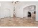 Open living space with travertine flooring, arched entryway, and lots of light at 6320 S 26Th Dr, Phoenix, AZ 85041