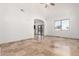 Open living space with travertine flooring, arched entryway, and lots of light at 6320 S 26Th Dr, Phoenix, AZ 85041