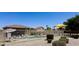 Community pool area surrounded by a white fence, with lounge chairs and shaded seating nearby at 6320 S 26Th Dr, Phoenix, AZ 85041