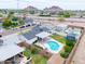 Scenic aerial view overlooking the property with a kidney-shaped pool, patio, and surrounding neighborhood at 6608 E Lewis Ave, Scottsdale, AZ 85257