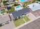 Aerial view of a home featuring a well-manicured front yard, complemented by desert landscaping and a basketball hoop at 6608 E Lewis Ave, Scottsdale, AZ 85257