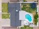 Aerial view of backyard with pool, firepit, patio, green lawn and trampoline at 6608 E Lewis Ave, Scottsdale, AZ 85257