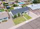 Aerial view of a home with a manicured front yard, desert landscaping, and a basketball hoop on the driveway at 6608 E Lewis Ave, Scottsdale, AZ 85257