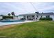 Large backyard featuring a pool, patio, and lush green grass, perfect for outdoor entertaining at 6608 E Lewis Ave, Scottsdale, AZ 85257