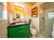 Stylish bathroom featuring a green vanity, gold fixtures, and a beautifully tiled walk-in shower at 6608 E Lewis Ave, Scottsdale, AZ 85257