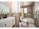 Neutral bathroom features a wood-look tile surround, updated vanity, and tub shower combo at 6608 E Lewis Ave, Scottsdale, AZ 85257