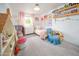 Cozy bedroom with a dollhouse, a crib, a plush armchair, and charming decor at 6608 E Lewis Ave, Scottsdale, AZ 85257