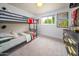 Stylish bedroom featuring a bunk bed, neutral carpet and walls, and natural lighting at 6608 E Lewis Ave, Scottsdale, AZ 85257