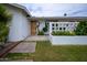 A charming single-story home with desert landscaping and a modern wood front door at 6608 E Lewis Ave, Scottsdale, AZ 85257