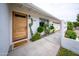 A charming single-story home with desert landscaping and a modern wood front door at 6608 E Lewis Ave, Scottsdale, AZ 85257