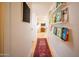 Inviting hallway with hardwood floors and built-in bookshelves showcasing a colorful book collection at 6608 E Lewis Ave, Scottsdale, AZ 85257