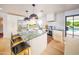 Modern kitchen boasts a large island with seating, stainless steel appliances, and ample counter space at 6608 E Lewis Ave, Scottsdale, AZ 85257