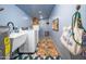 Functional laundry room with a large sink, washer, dryer, and stylish blue patterned floor at 6608 E Lewis Ave, Scottsdale, AZ 85257