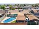 Overview of the home featuring a pool, shaded patio, and well-kept landscaping at 6838 E Belleview St, Scottsdale, AZ 85257