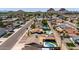 Scenic aerial view of residential neighborhood featuring pools, manicured landscapes, and mountain views at 6838 E Belleview St, Scottsdale, AZ 85257