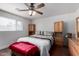 Comfortable bedroom with ceiling fan and built-in wood cabinets on either side of the bed at 6838 E Belleview St, Scottsdale, AZ 85257