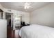 Bright bedroom with ceiling fan, hardwood floors, built-in desk, and mirrored closet at 6838 E Belleview St, Scottsdale, AZ 85257