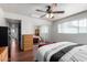 Bedroom with ceiling fan, closet with mirrored sliding doors, and hardwood floors at 6838 E Belleview St, Scottsdale, AZ 85257