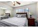 Comfortable bedroom with hardwood floors, ceiling fan, and sliding door closet at 6838 E Belleview St, Scottsdale, AZ 85257