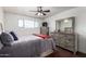This is a cozy bedroom with a ceiling fan and a chest of drawers at 6838 E Belleview St, Scottsdale, AZ 85257