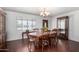 Traditional dining room featuring hardwood floors, a wood table with chairs, and elegant chandelier lighting at 6838 E Belleview St, Scottsdale, AZ 85257