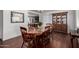 Classic dining room boasts wood floors, a table for six, and a decorative hutch for storage at 6838 E Belleview St, Scottsdale, AZ 85257