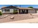 Charming single-story home featuring stone accents, a red door, and desert landscaping at 6838 E Belleview St, Scottsdale, AZ 85257