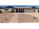 Charming single-story home featuring rock landscaping and a brick walkway to the inviting red front door at 6838 E Belleview St, Scottsdale, AZ 85257