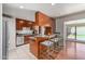 Open kitchen with stainless steel appliances, breakfast bar seating, and a view to the outdoor pool at 6838 E Belleview St, Scottsdale, AZ 85257