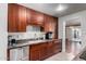Well-appointed kitchen featuring warm wood cabinets, a stainless steel dishwasher, and granite countertops at 6838 E Belleview St, Scottsdale, AZ 85257