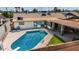 Aerial view of a sparkling pool with a diving board and a cozy patio area at 6838 E Belleview St, Scottsdale, AZ 85257