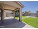 The backyard features artificial turf, pavers, and a covered patio for outdoor enjoyment and relaxation at 763 E Maddison St, San Tan Valley, AZ 85140