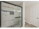 Bathroom features a sleek glass shower with marble tile, a built-in shelf, and modern fixtures at 763 E Maddison St, San Tan Valley, AZ 85140