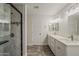 Spacious bathroom with double sinks, granite countertops, white cabinets, and modern fixtures at 763 E Maddison St, San Tan Valley, AZ 85140