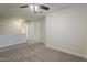 An empty room with neutral carpet, ceiling fan, and fresh paint offers a blank canvas to personalize at 763 E Maddison St, San Tan Valley, AZ 85140
