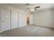 Bedroom boasts fresh paint, neutral carpet, and a ceiling fan, creating a cozy and inviting space at 763 E Maddison St, San Tan Valley, AZ 85140