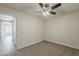 Empty room featuring a ceiling fan, neutral carpet, fresh paint, and ample natural light at 763 E Maddison St, San Tan Valley, AZ 85140