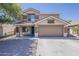 Two-story home with a two-car garage, neutral color palette, and low-maintenance landscaping, exemplifying suburban charm at 763 E Maddison St, San Tan Valley, AZ 85140