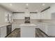 Bright kitchen with white cabinets, an island, stainless steel appliances, and a view from the window at 763 E Maddison St, San Tan Valley, AZ 85140
