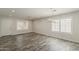 Open living room with abundant natural light, tile floors, modern lighting, and views to the entry door at 763 E Maddison St, San Tan Valley, AZ 85140