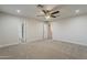 Main bedroom featuring plush carpeting, a ceiling fan, ample natural light, and access to the bathrooms at 763 E Maddison St, San Tan Valley, AZ 85140