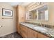Well-lit bathroom featuring granite countertops, modern vanity, and decorative light fixture at 7673 N Via De Platina Dr, Scottsdale, AZ 85258