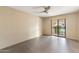 Empty bedroom with tile flooring, ceiling fan, and access to an enclosed patio at 7673 N Via De Platina Dr, Scottsdale, AZ 85258