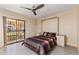 Cozy bedroom with modern ceiling fan, built-in bed, and private patio access at 7673 N Via De Platina Dr, Scottsdale, AZ 85258